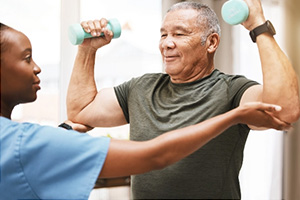 A rehab therapist with a resident in the rehab gym