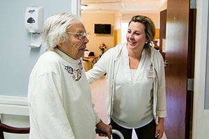 a nurse and a resident in the hallway of Richwood Nursing & Rehab